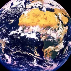 Jorden snurrar, med Afrika tydligt synligt. Moln virvlar över blå hav och gulbruna landmassor.