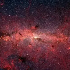 En glödande röd nebulosa fylld av stjärnor, som visar vad universum består av.
