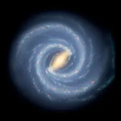 En bild av spiralformade galaxer med en ljusgul kärna och blåa armar fyllda med stjärnor och gas.