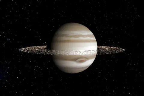 En gasjätte med band av moln och tunna, glittrande jupiter ringar mot en stjärnklar bakgrund.