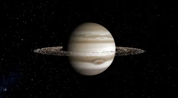 En gasjätte med band av moln och tunna, glittrande jupiter ringar mot en stjärnklar bakgrund.