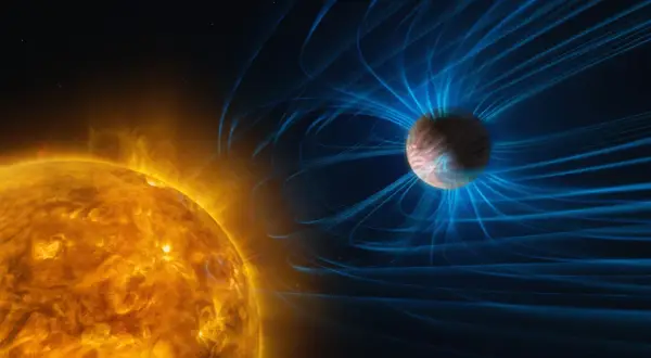 Solens glödande yta och Saturnus med sitt magnetfält. Bilden illustrerar solens enorma energi och avståndet från solen till Saturnus.