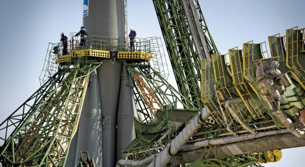 Arbetare inspekterar en raket vid Baikonur kosmodrom.
