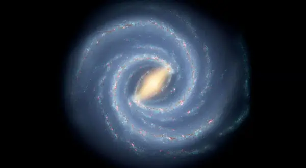 En bild av spiralformade galaxer med en ljusgul kärna och blåa armar fyllda med stjärnor och gas.